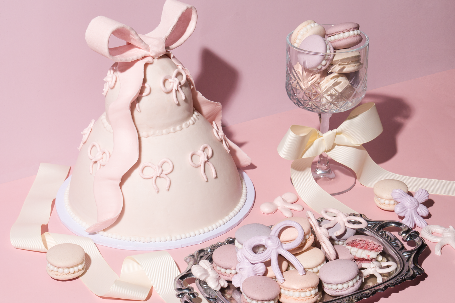 Meringue bow cake and pearl macarons made with Colour Mill Aqua Blend water-based food colouring.
