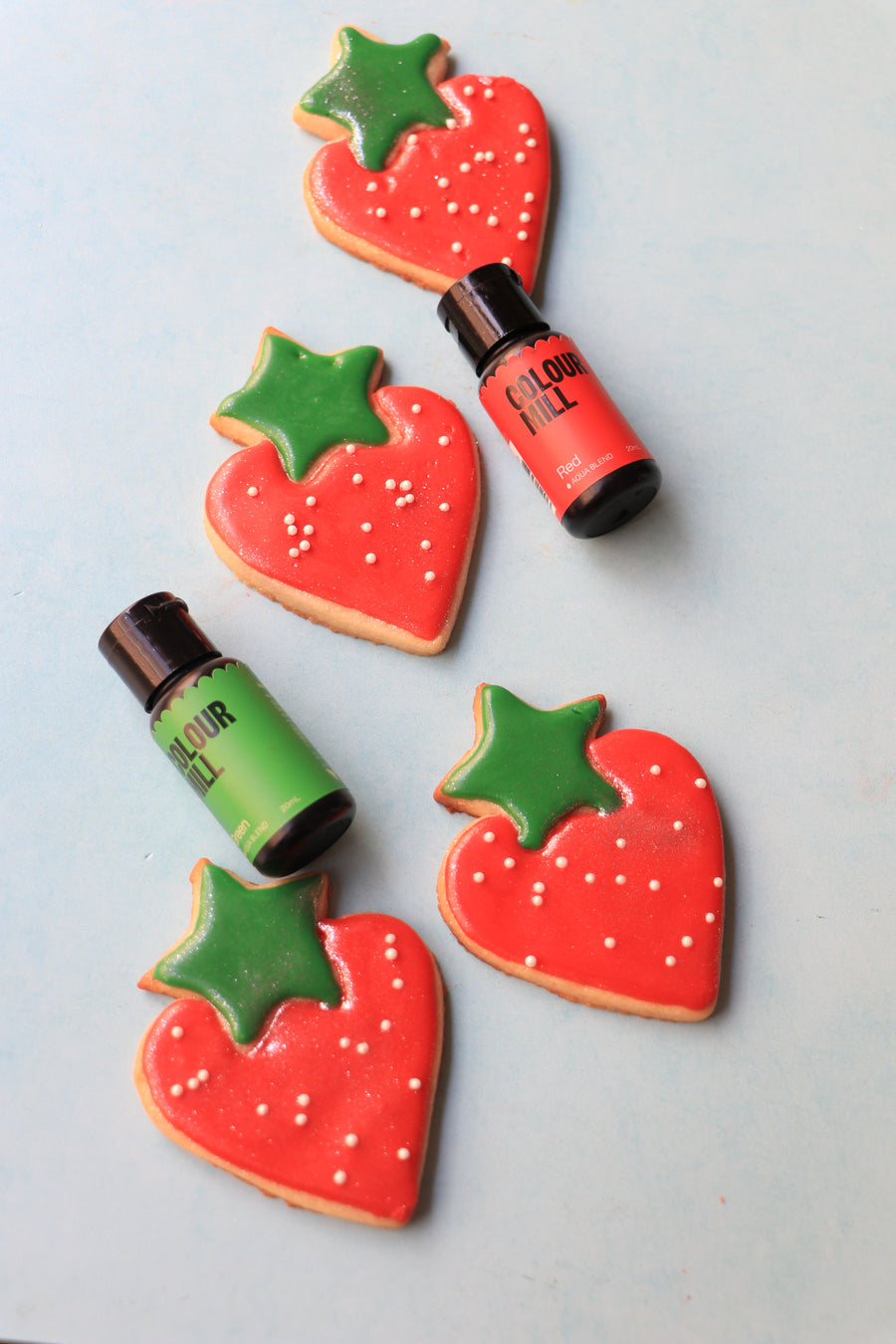 Strawberry sugar cookies decorated and coloured with Colour Mill Red and Green Aqua Blend 