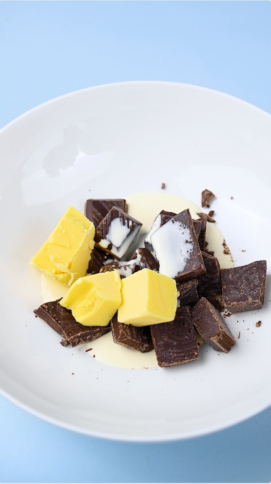 Cube Dark Chocolate, Salted Butter and Thickened Cream and place together in a bowl.