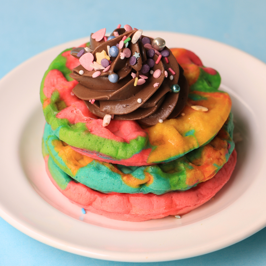 Rainbow Waffle Recipe served with Chocolate Buttercream, Sprinkles and Maple Syrup.