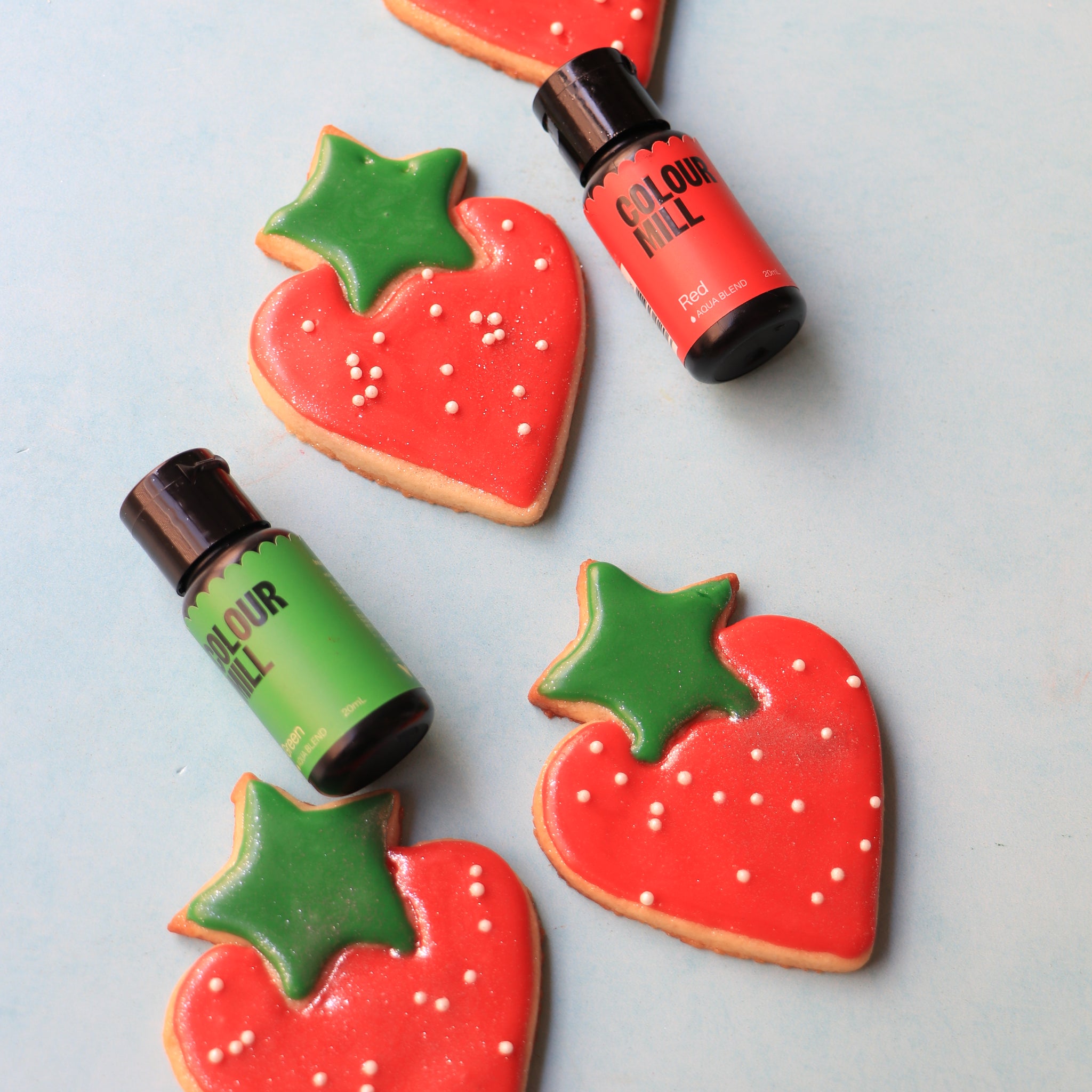 Strawberry sugar cookies decorated and coloured with Colour Mill Red and Green Aqua Blend 