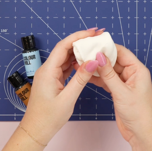 Softening fondant to prepare to colour it with Colour Mill Aqua Blend